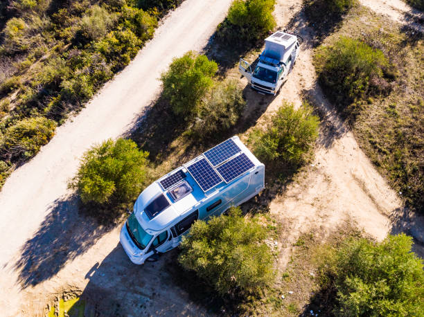 An RV equipped with solar panels is in the wild